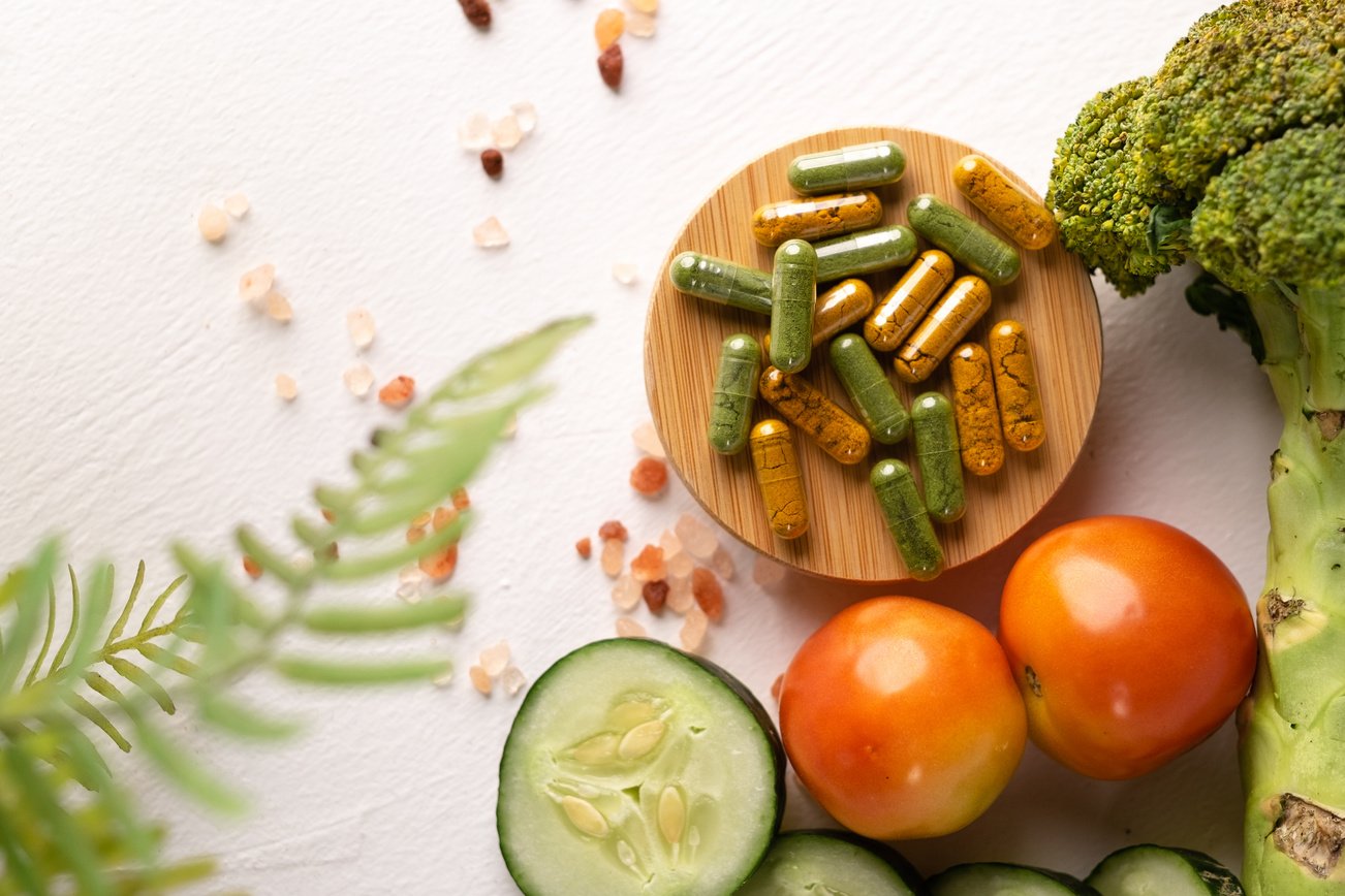 Capsules with Fresh Vegetables on White Background